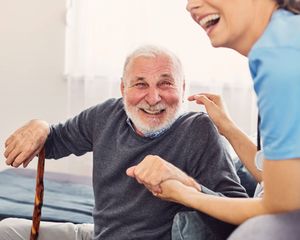 Professional nurse providing compassionate care to elderly resident at Maygrove Lifecare