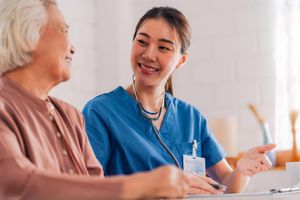 A Maygrove Lifecare nurse sharing a warm moment with a resident